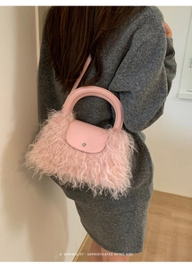 Detailed view of pink faux fur crossbody bag featuring a retro silver metal buckle
