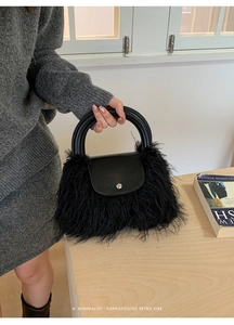 Detail of black faux fur plush handbag showing matte leather flap and metal clasp