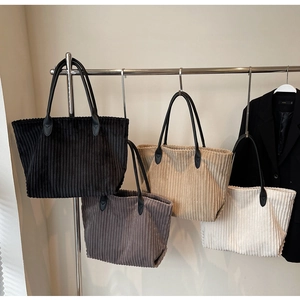 Detail of soft corduroy tote bags with reinforced handles in four assorted colors