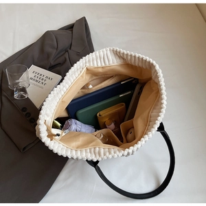 Macro view of white corduroy tote bag interior with large capacity for daily items