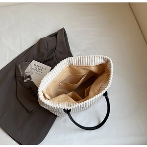 Interior view of white corduroy tote bag showing zipper pocket and spacious compartments