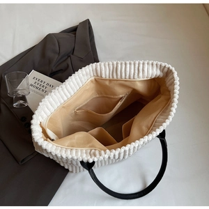 Detailed interior of the corduroy tote bag showing large capacity and inner pockets