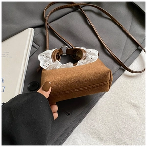 Détail du mini sac bandoulière en similicuir marron avec bordure en dentelle blanche et lanière