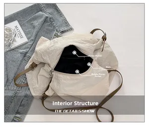 Interior view of beige nylon tote bag showing zipper pocket and phone compartments