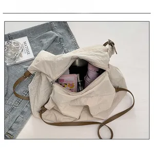 Detail showing the large capacity of the beige nylon tote bag with leather straps