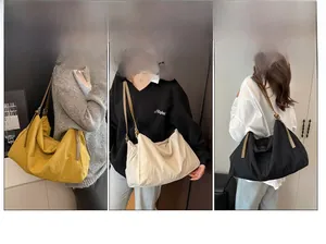 Detailed view of lightweight nylon tote bags in yellow, beige and black with zippers