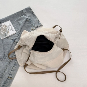 Detail view of large nylon tote bag showing inner lining, pocket, and zipper closure