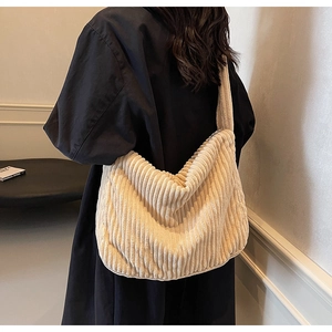 Detail view of large beige corduroy tote bag showing soft texture and spacious slouchy design