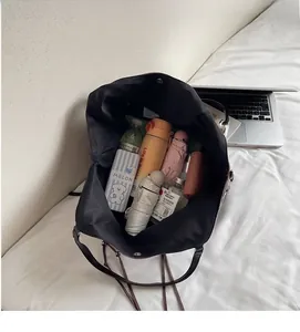 Innenansicht mit großem Stauraum der schwarzen Shopper-Tasche und Alltagsgegenständen