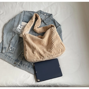 Detail of soft corduroy tote bag showing spacious interior fitting a tablet device