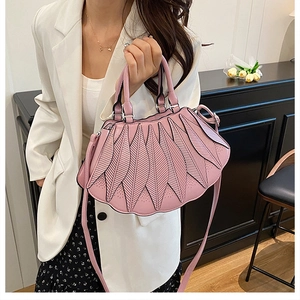 Detail einer hellrosa Handtasche mit einzigartigem Schichtblattmuster für Frauen