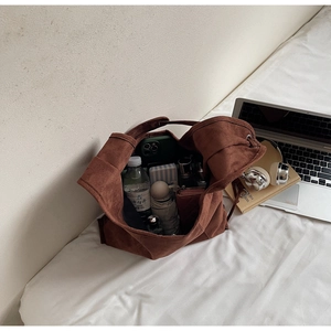 Interior view showing the large capacity of this brown suede tote bag with daily essentials