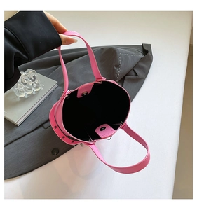 Detailed interior of a pink studded bucket bag with magnetic closure and black lining