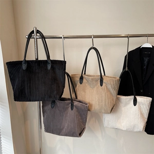 Corduroy tote bags in four colors with black leather handles for daily commuting