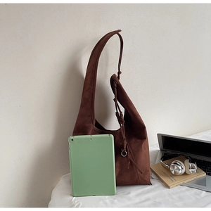 Detail of spacious brown suede tote bag showing tablet fitting inside for daily commute