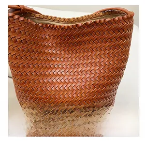 Macro view of brown woven leather texture and braided trim on this bucket bag