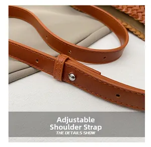 Detail of adjustable brown leather shoulder strap with silver buckle and fine stitching