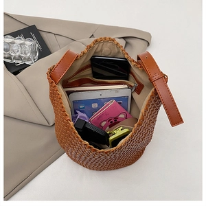 Detail of dark brown hand-woven bucket bag with large capacity for a tablet and wallet