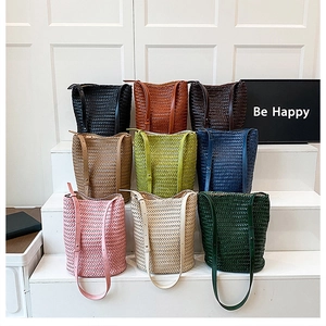 Detailed display of handcrafted woven bucket bags in nine vibrant colors with straps