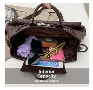Macro view showing large interior capacity of brown woven leather tote with daily essentials