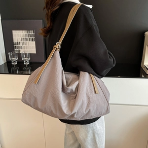 Minimalist large nylon tote bag in dusty purple with brown leather strap for commuting