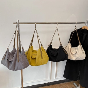 Minimalist large tote bags in four colors with adjustable straps on display