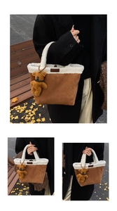 Brown suede tote bag with white plush trim and cute bear charm in autumn park setting