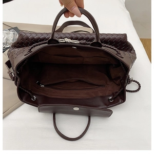 Detailed top view of a large woven tote bag interior with zip pocket and suede lining