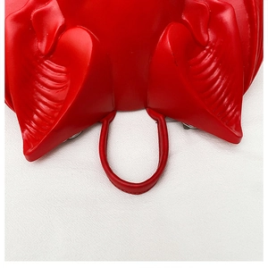 Close-up of red bat wing relief texture on creative gothic punk crossbody bag detail