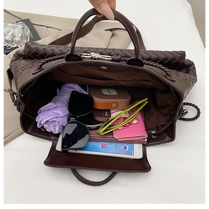 Top view of spacious interior of dark brown woven tote bag holding a tablet and umbrella