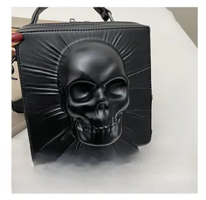 Detailed macro view of 3D skull design on black leather crossbody gothic bag
