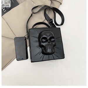 Detailed view of black gothic skull crossbody bag with 3D embossed skull and shoulder strap