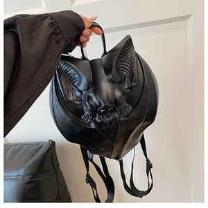 Close-up of a gothic black leather bat-shaped backpack with wing details and sleek matte finish
