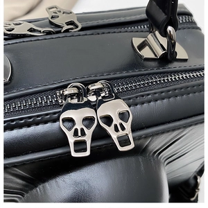 Detail of silver skull dual zipper and leather texture on gothic rock shoulder bag