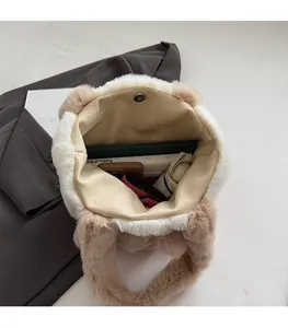 Top-down view of spacious interior in plush tote bag holding books and daily essentials