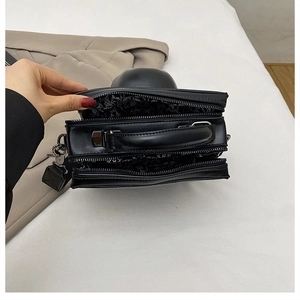 Detailed interior view of punk skull bag with multi-layer zipper pockets and vintage lining