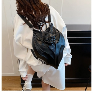 Detailed close-up of 3D gothic bat backpack wings in premium black faux leather