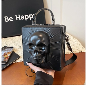 Detailed view of 3D skull embossment on black matte leather gothic crossbody bag