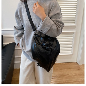 Gothic punk black bat shoulder bag with 3D embossed wing details worn by model