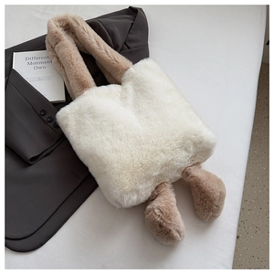 Detail of white and brown plush tote bag showing soft faux fur texture and contrast handles