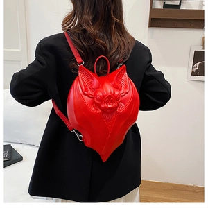 Detailed view of the 3D bat backpack in red PU leather with embossed wing textures
