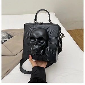 Close-up of the 3D matte skull relief on a black gothic PU square crossbody bag