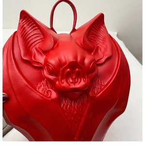 Detailed relief texture and wing patterns on the red gothic bat-shaped crossbody bag