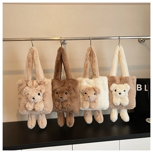 Front view of four plush teddy bear tote bags in khaki and brown on a display stand