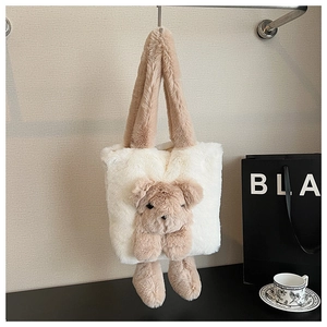 Detail of plush tote bag featuring 3D brown teddy bear and soft faux fur texture