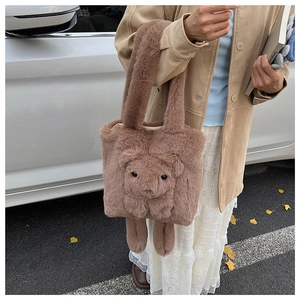 Detail of a brown plush tote bag with 3D teddy bear design and soft faux fur handle