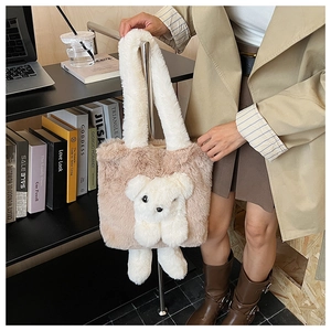Detail of plush brown tote bag featuring a 3D white teddy bear and soft fleece handle
