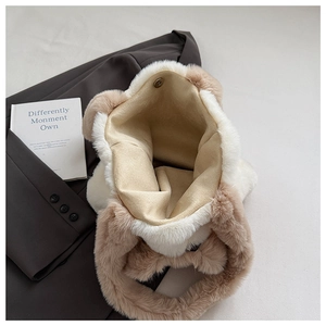 Detail of cute plush bear-shaped tote bag showing brown-white faux fur and magnetic closure