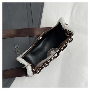 Overhead view showing the magnetic clasp and interior of this brown lambskin patchwork bag
