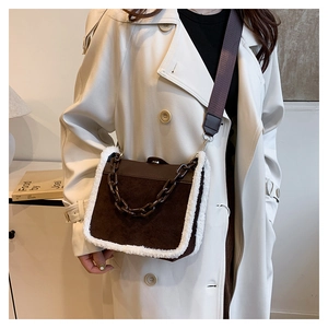 Brown suede crossbody bag with plush faux fur trim and chunky chain strap detail